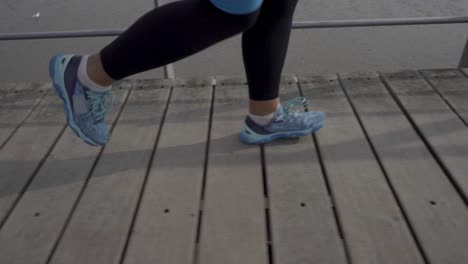 Confident-sporty-female-runner-training-outdoor